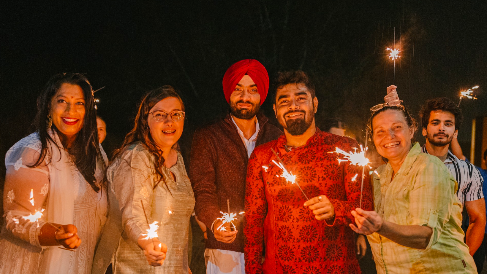 NUSU hosts Diwali Celebrations - Sparklers are lit and a crowd is smiling.